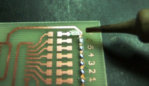 Soldering SMD by hand: putting the device in place and fixing it with the soldering iron.