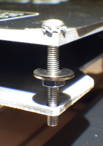 A shakeproof washer and a nut secure the M3 screw.